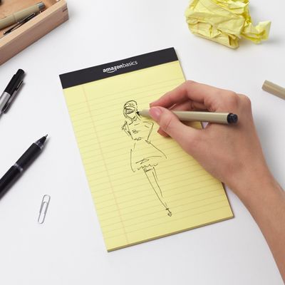 AmazonBasics catalogue image: A yellow pad in use. Hand, pen and other props are not included.