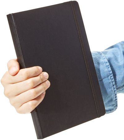 AmazonBasics Hardcover planner and diary: Planner held in a hand; not a measured scale.